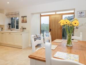 a kitchen and dining room with a table and chairs at Lavender Cottage in York