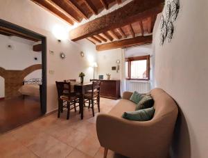 a living room with a couch and a table at San Gimignano Apartments Vernaccia in San Gimignano