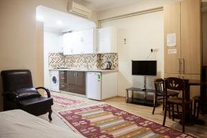 a room with a kitchen and a living room at Sheriff Royal Suite in Istanbul