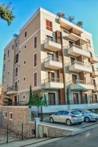 two cars parked in front of a building at Hotel Villa Gracia in Budva