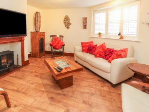 a living room with a couch and a fireplace at Heath Corner in Knutsford