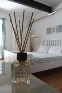 a bottle with sticks in it on a table in a bedroom at Casa Silvia in Genova