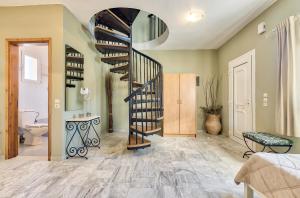 a living room with a spiral staircase in a house at Avesta Apartments in Vasilikos