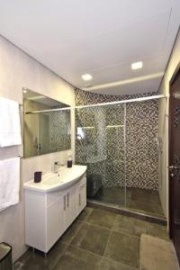 a bathroom with a white sink and a shower at Northern Avenue 2 bedrooms New and Modern apartment in New Elite Building HH600 in Yerevan +24 photos