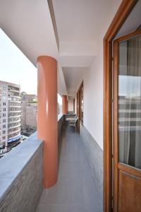 an office corridor with orange columns on a building at Northern Avenue 2 bedrooms New and Modern apartment in New Elite Building HH600 in Yerevan