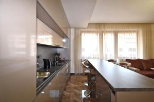 a kitchen with a counter and a living room at Northern Avenue 2 bedrooms New and Modern apartment in New Elite Building HH600 in Yerevan