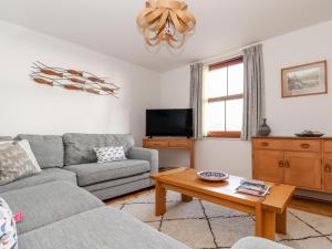 a living room with a couch and a coffee table at Ocean Blue in Penzance