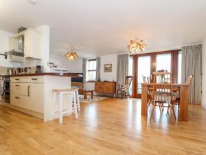 a kitchen and dining room with a table and chairs at Ocean Blue in Penzance
