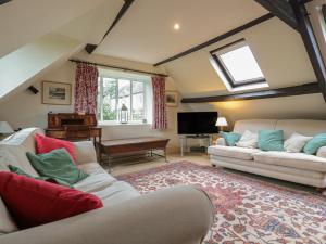 a living room with two couches and a tv at Little End in Stroud