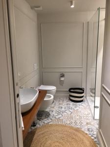 a bathroom with two sinks and two toilets at Suites Menaggio in Menaggio