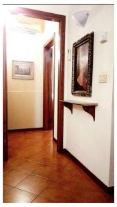 a hallway with a painting on a wall and a door at Booking San Marco Apartment in Venice