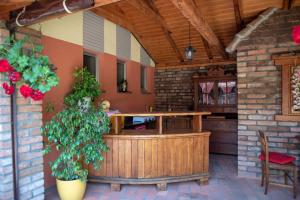 an outdoor patio with a wooden table and a bench at Apartmani Špoljar in Županja