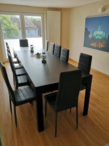 a conference room with a large table and chairs at SOVA Pension Baunatal in Baunatal