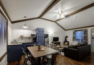 a kitchen and living room with a table and chairs at Bramblebank Cottages in Harrison Hot Springs
