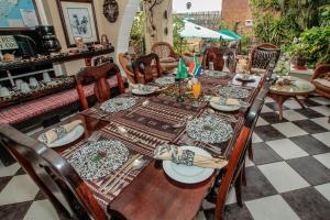 a wooden table with chairs and plates on it at Acorn B&B in Durban in Durban