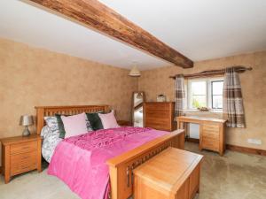 a bedroom with a large bed and a window at Chapel House in Stonehouse