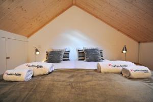 a bedroom with a large bed with pillows on it at FLH Oporto Wine Cellars Luxury Apartment II in Vila Nova de Gaia