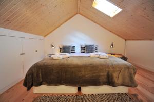 a bedroom with a large bed in a attic at FLH Oporto Wine Cellars Luxury Apartment II in Vila Nova de Gaia