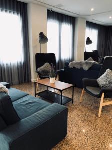 a living room with couches and a coffee table at Plaza Regency Hotels in Sliema