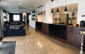 a lobby with a bar with couches and a kitchen at Plaza Regency Hotels in Sliema