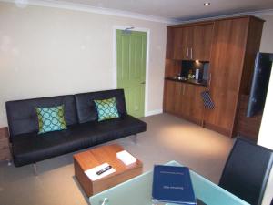 a living room with a couch and a coffee table at Bagshaw Lodge in Bakewell