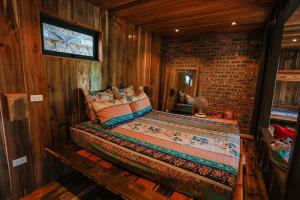 a bedroom with a bed in a wooden room at GISY Lake House 1F in Hanoi