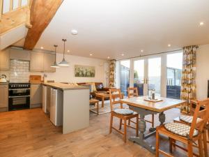 a kitchen and living room with a table and chairs at The Hayloft in Harrogate