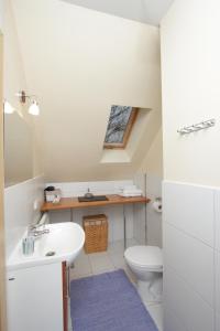 a bathroom with a sink and a toilet at Vila Ramybe in Palanga