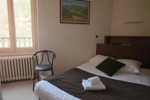 Postel nebo postele na pokoji v ubytování Hotel Au Val Doré