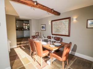 a dining room with a table and chairs at Woodside Barn in Thirsk