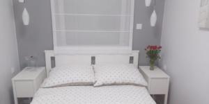Una cama o camas en una habitación de Apartament Plac Jana Pawła