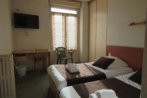 Postel nebo postele na pokoji v ubytování Hotel Au Val Doré
