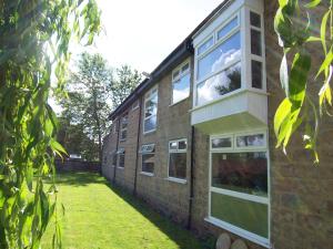 a brick building with windows on the side of it at Bagshaw Lodge in Bakewell