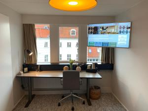 A television and/or entertainment centre at Rungstedgaard