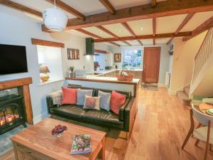 a living room with a couch and a fireplace at May Cottage in Scarborough