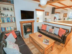 a living room with a couch and a fireplace at May Cottage in Scarborough