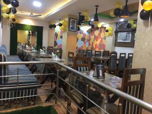 a dining room with tables and chairs and balloons at Traveller Guest House in Varanasi
