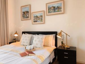 a bedroom with a bed with two books on it at Poseidon's Luxury Apartment in Paphos