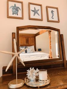 a bedroom with a bed and a mirror on a table at Poseidon's Luxury Apartment in Paphos
