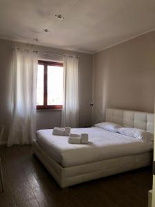 a bedroom with a large white bed with a window at Hotel Eremo in Soriano nel Cimino