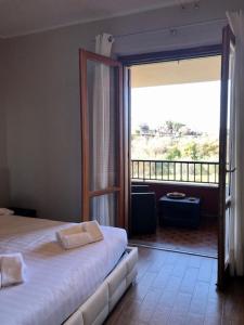 a bedroom with a bed and a sliding glass door at Hotel Eremo in Soriano nel Cimino