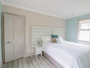 Ένα ή περισσότερα κρεβάτια σε δωμάτιο στο Saxon Lodge Cottage