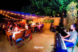 a group of people sitting at a restaurant with a keyboard at 1Hotels in Timişoara