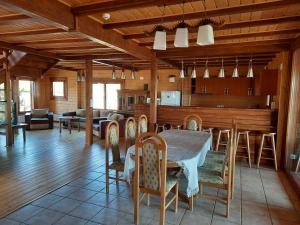 a dining room and kitchen with a table and chairs at Sat de vacanta Ciprian Porumbescu in Suceava +52 photos