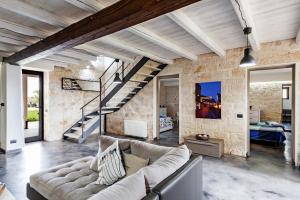 Villa Antica Aia Relax في شيكلي: غرفة معيشة مع أريكة ودرج