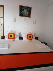 Postelja oz. postelje v sobi nastanitve New SeaSide Inn Hikkaduwa