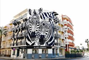 a mural of zebras on the side of a building at Las Cebras Apartamentos Turísticos in Benicarló