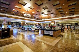 a lobby of a hotel with people walking in it at Utopia World in Kargicak
