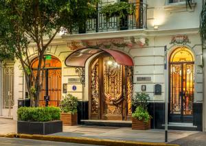 a building with a large wooden door on a street at Duque Hotel Boutique & Spa in Buenos Aires