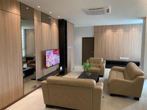 a living room with two couches and a flat screen tv at 3Bedroom Rex Apartment 5min Drive to Vivacity in Kuching